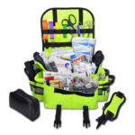 Small EMT first responder bag with reflective striping, padded shoulder strap, multiple zippered compartments, and stocked with basic first aid and trauma supplies including bandages, gauze, shears, gloves, and more. Compact and ideal for emergency medical use in vehicles, schools, or workplaces, available in red, black, blue, orange, fluorescent yellow, purple and pink