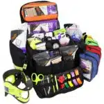 Open black trauma kit with 6 accessory pouches stocked with professional emt supplies