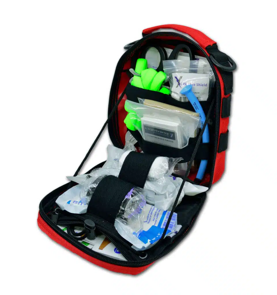 Red first aid pouch opened and stocked with CPR shield, gauze and supplies