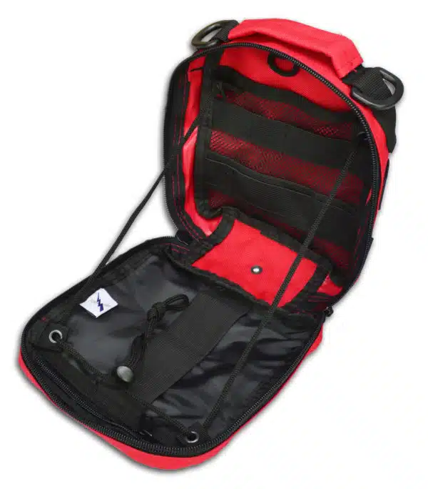 Red first aid pouch opened flat showing black mesh interior pockets
