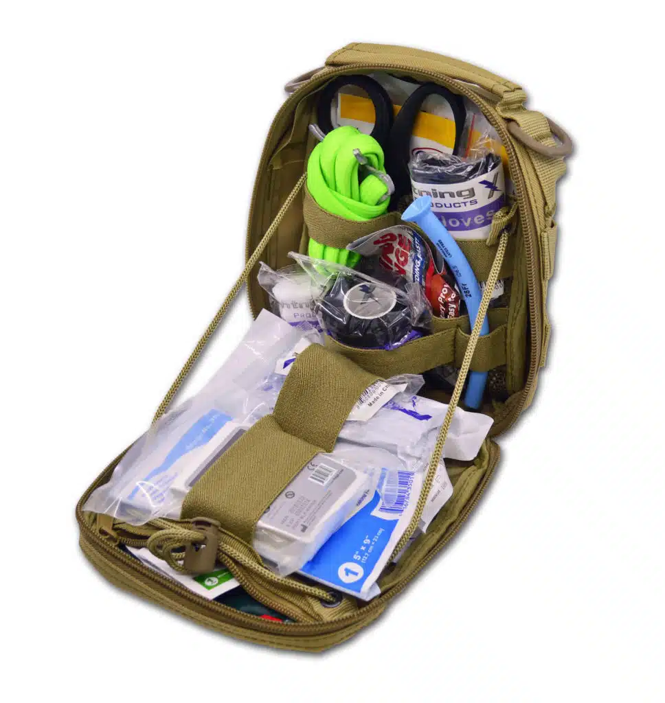 Tan first aid pouch opened and stocked with rolled gauze, gloves and medical supplies