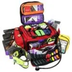 Open red emt first responder med kit with color-coded accessory pouches stocked with trauma supplies