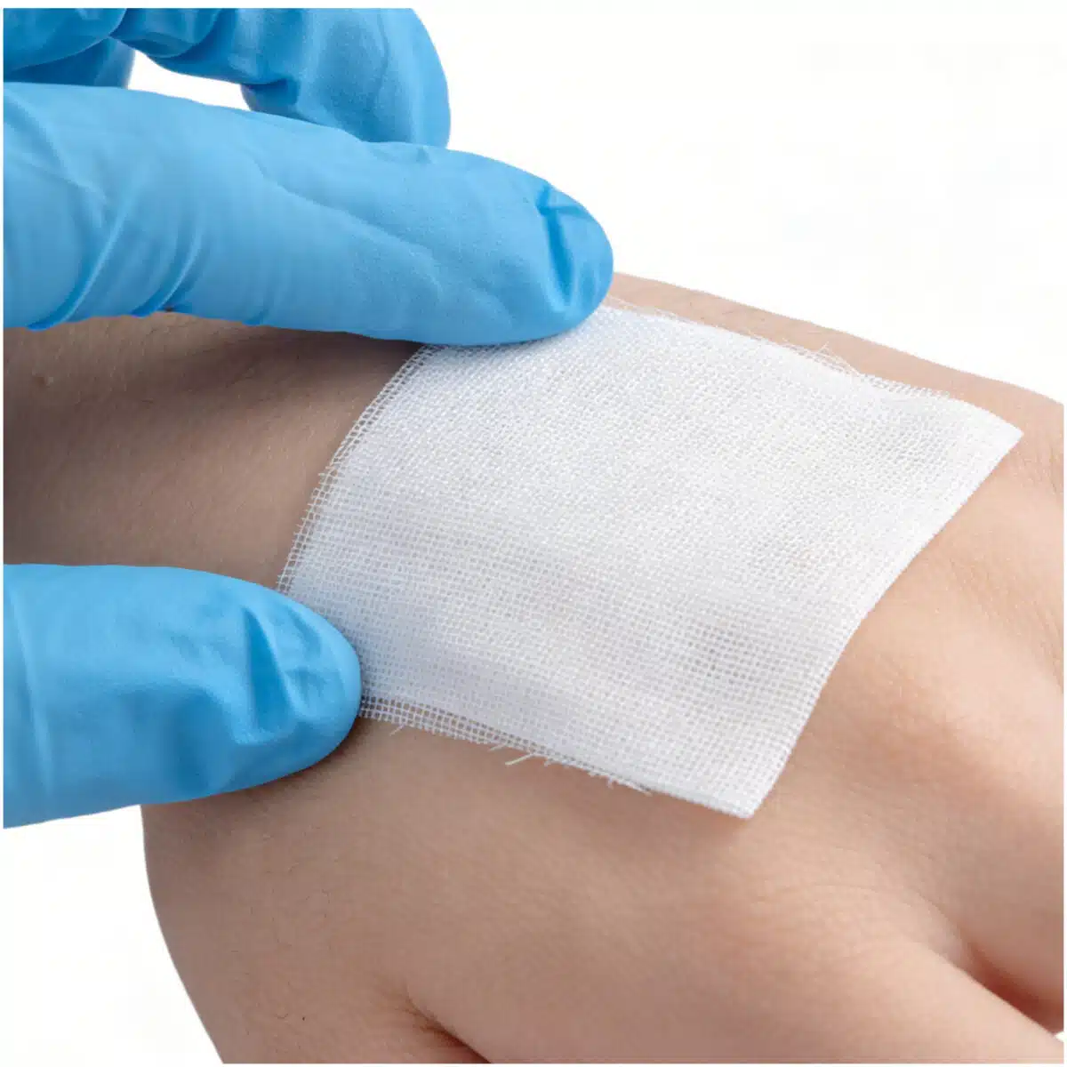 blood clotting gauze being applied to wound on hand