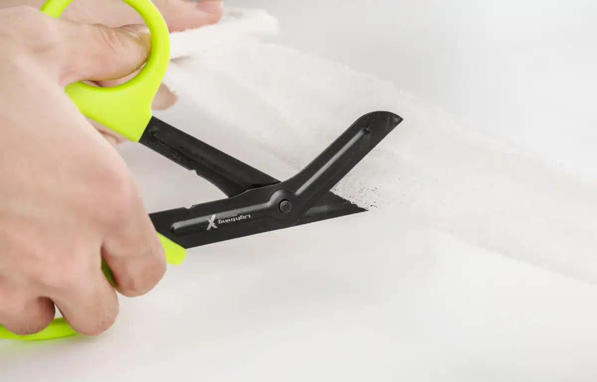 Krinkle gauze being cut with trauma shears