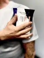 Man holding an instant cold pack to his shoulder
