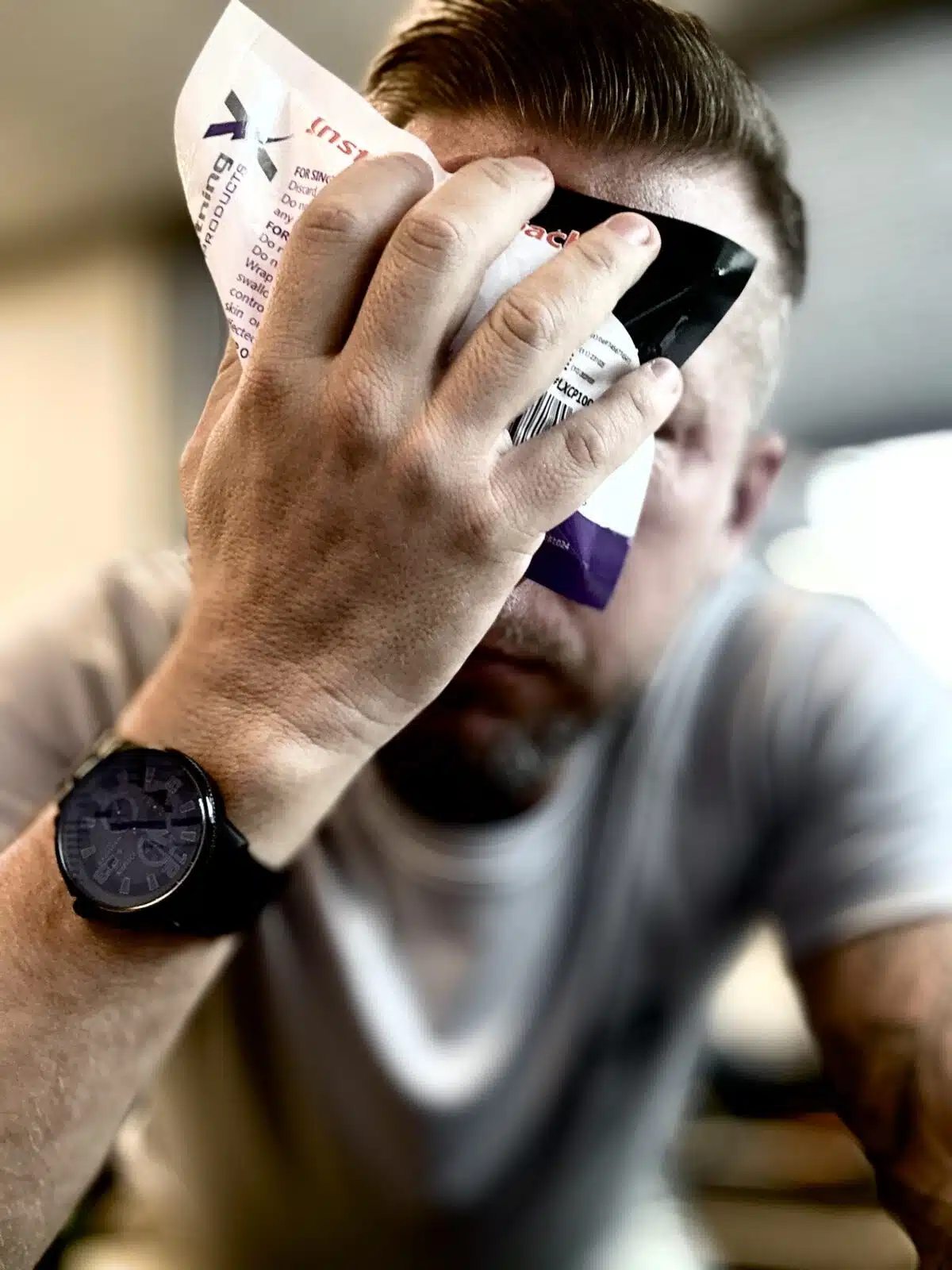 Man holding an instant ice pack to his forehead
