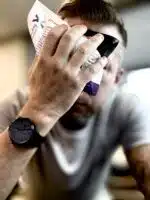 Man holding an instant ice pack to his forehead