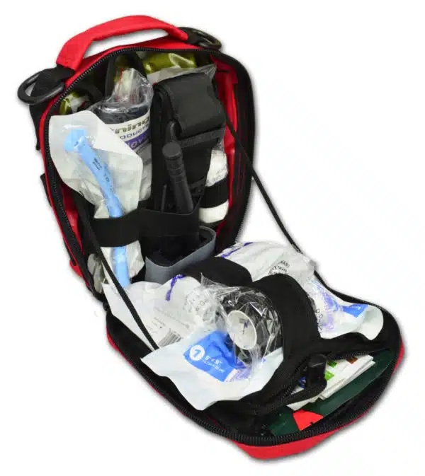 Red trauma pouch open and stocked with airway, dressings and supplies