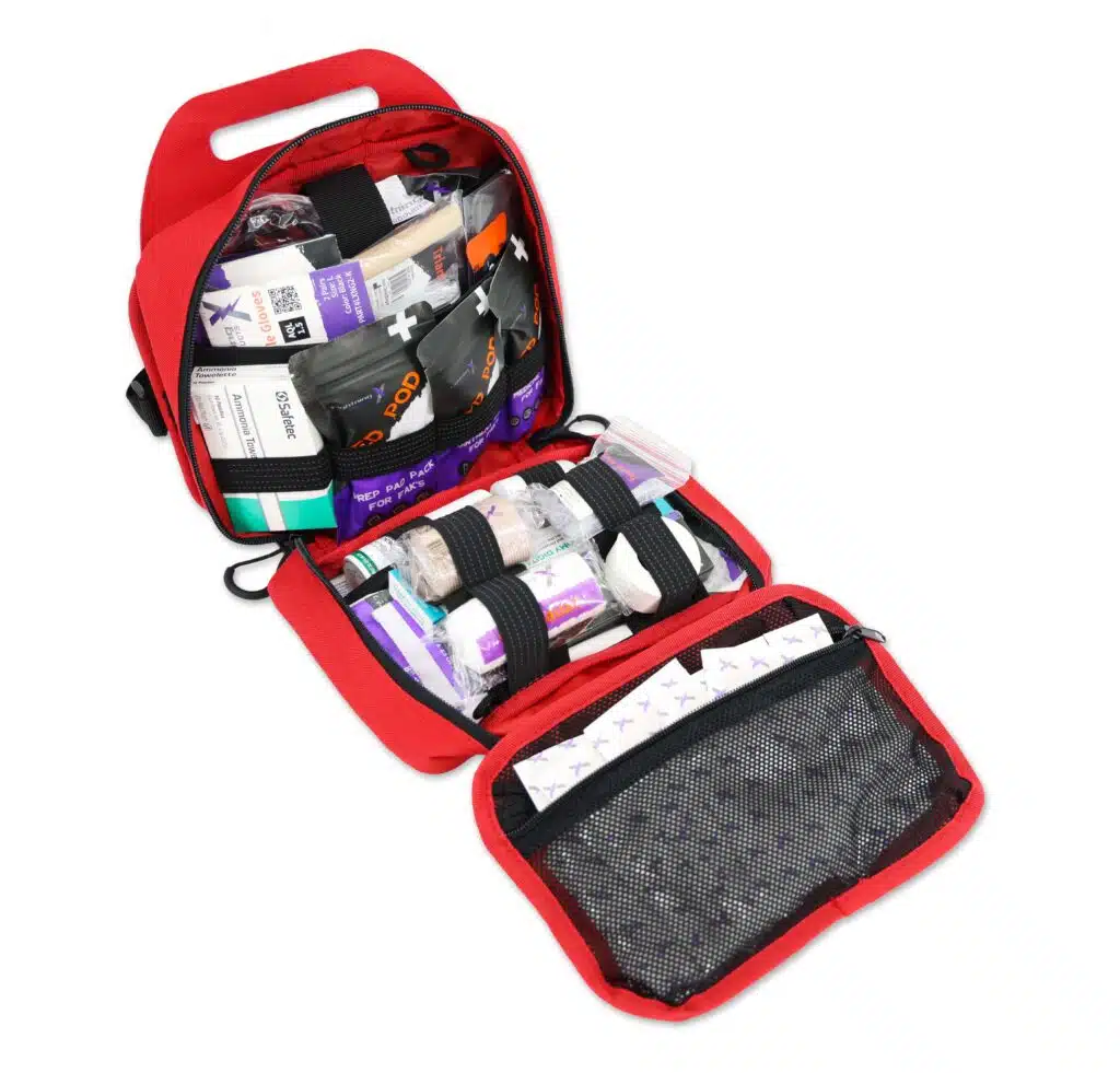 Open red first-aid pouch fully stocked with dressings, gauze and supplies