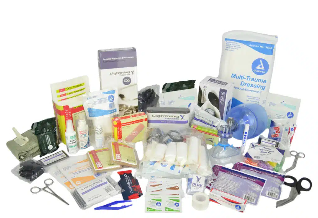 Spread of EMS fill-kit supplies including dressings, bandages, airway items and trauma shears