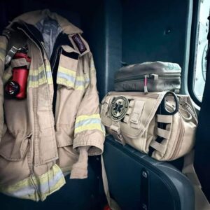 Tactical medical kit and turnout jacket in fire truck passenger compartment