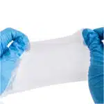 blood clotting gauze being stretched with gloved hands