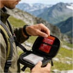 lifestyle image of a man removing clotting gauze from go back