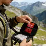 lifestyle image of a man removing clotting gauze from go back