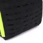 Black laser-cut MOLLE attachment panel with fluorescent yellow trim along the edge of a tactical backpack