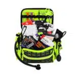 Hi-vis yellow trauma bag open at an angle, packed with chest seals, hemostatic gauze and bandages