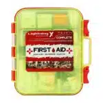 Red hi-vis hard-case first aid kit, closed, with a printed Complete First Aid label and OSHA ANSI Class B markings