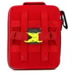 Back of a red soft-shell first aid kit showing MOLLE webbing, buckle straps and a sewn identification label