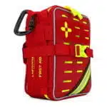 Red soft-shell first aid kit, closed and angled, with the hi-vis yellow cross, laser-cut MOLLE slots and reflective stripe