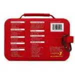 Back of a red waterproof first aid case showing the full printed contents list and ANSI compliance on the shell