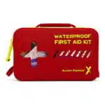 Red waterproof first aid case, closed, with hi-vis yellow “Waterproof First Aid Kit” print and a clear cross window