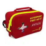 Red waterproof IPX7 first aid case at an angle, showing the molded shell, hi-vis yellow zipper and carabiner clip