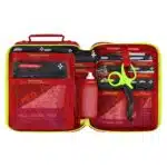 Open red waterproof first aid case with organized trauma supplies and color-coded pouches in mesh pockets