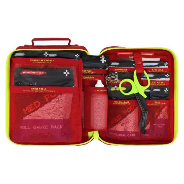 Open red waterproof first aid case with organized trauma supplies and color-coded pouches in mesh pockets