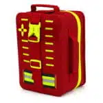 Red waterproof first aid case, angled closed view showing the molded shell side, hi-vis zipper, cross panel and buckle strap